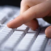 Woman typing on a keyboard