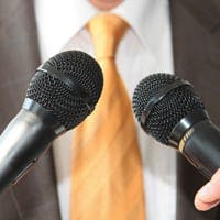 Man with microphones in front of him