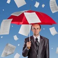 Man under umbrella as papers fall around him