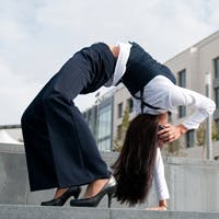 Woman on the phone doing acrobatics