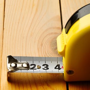 Measuring tape on wooden bench