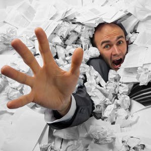 man buried in paperwork