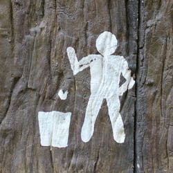 Silhouette of man throwing away rubbish