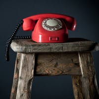 Red phone on stool