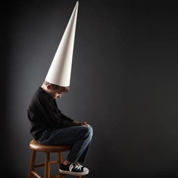 Little boy wearing dunce hat