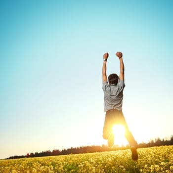 Man jumping for joy in field