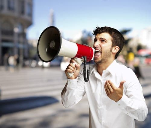 man shouting through megaphone