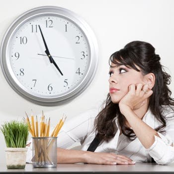 Bored looking employee watching the clock