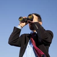 Man looking through binoculars